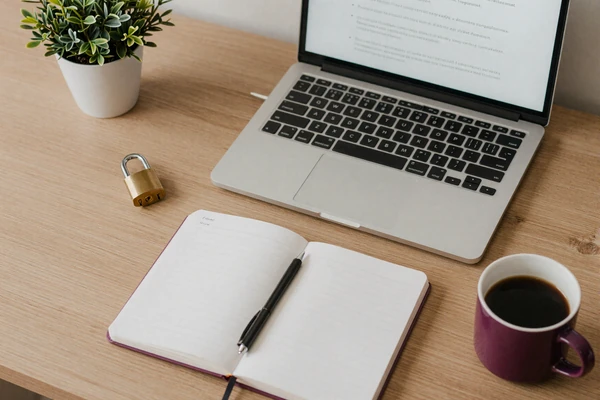 Desk with laptop and padlock representing online dating safety practices